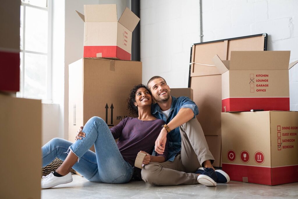  two people hugging in front of boxes