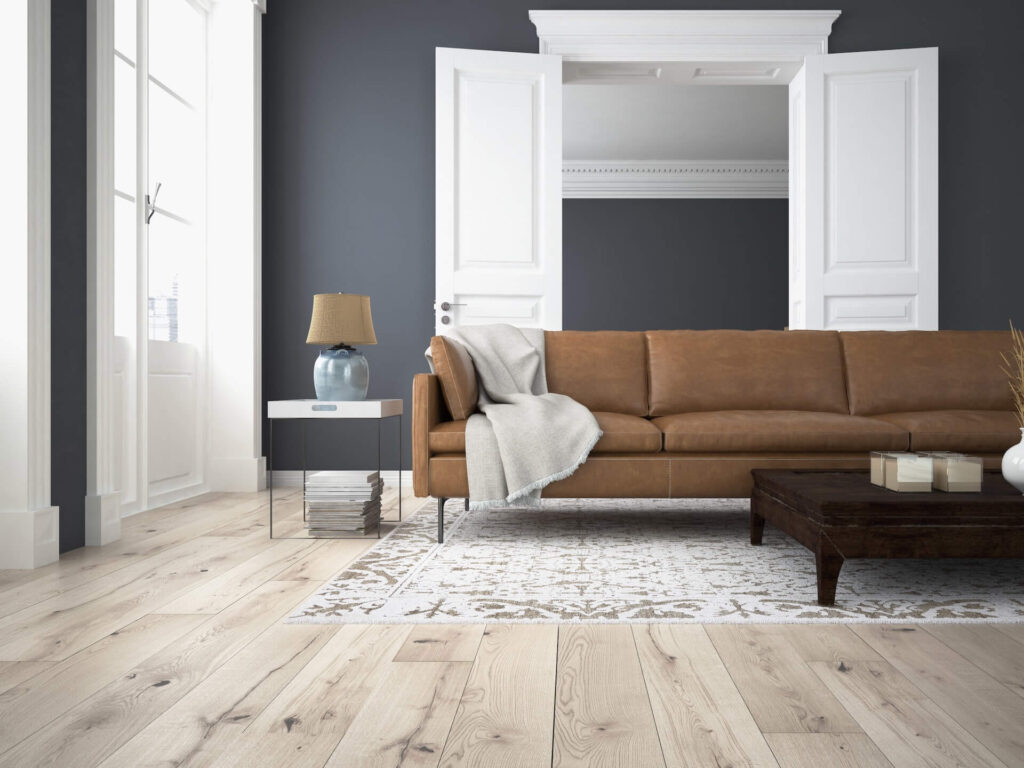 A tan couch in a blue-painted living room