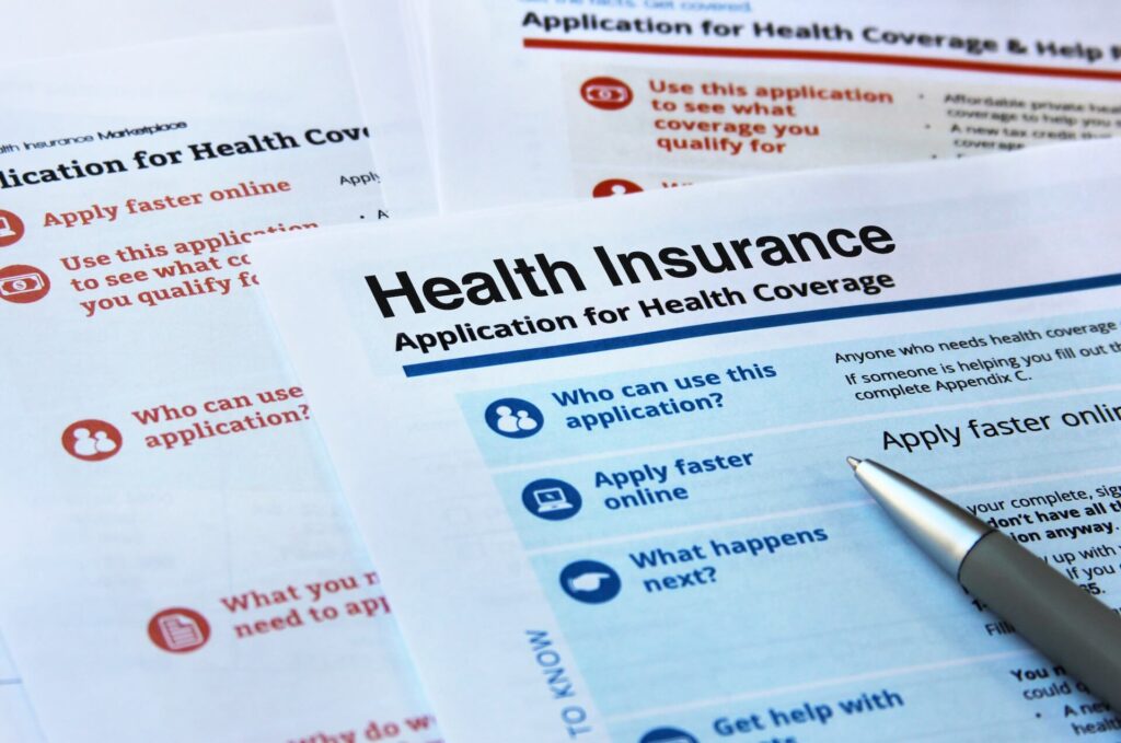 Health insurance application form and a pen