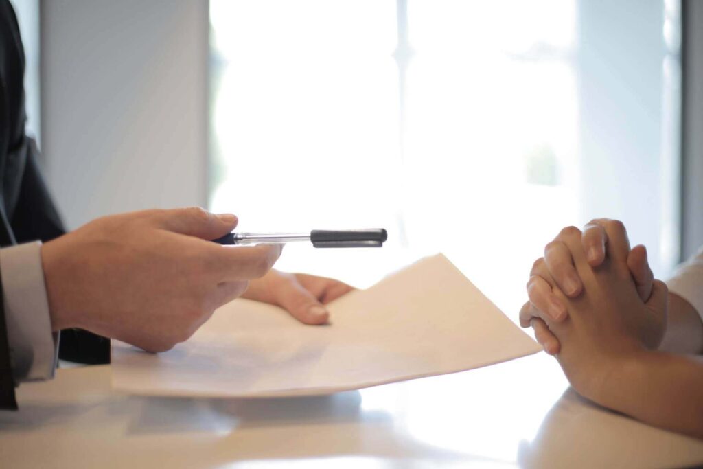 Two people signing papers