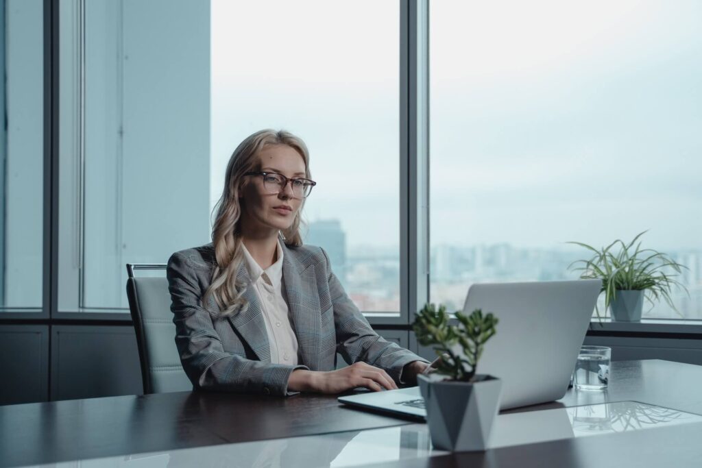 A woman working on a laptop computer in an office