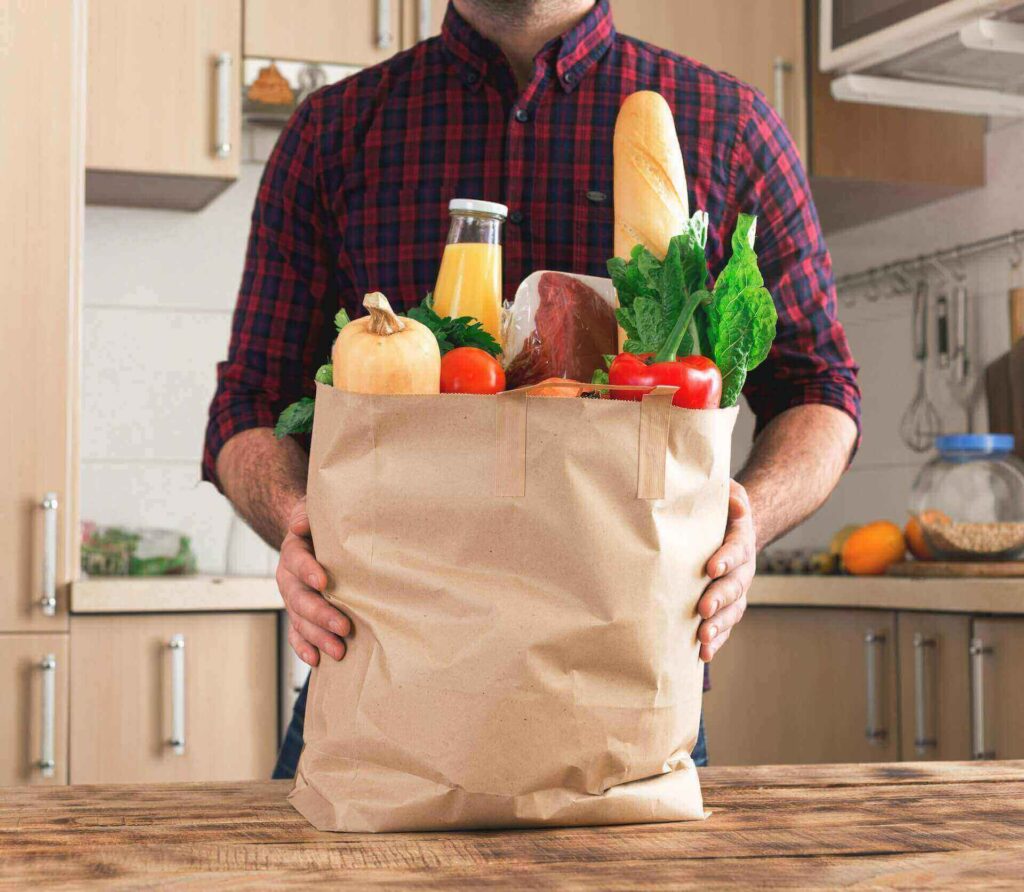 A man holding a bag of groceries