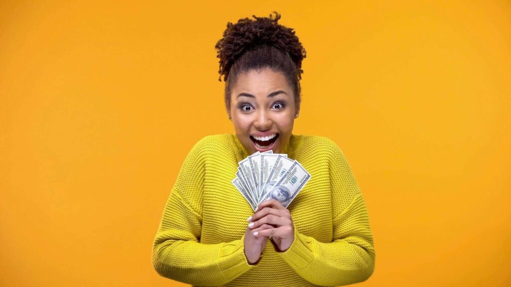 A happy woman holding money
