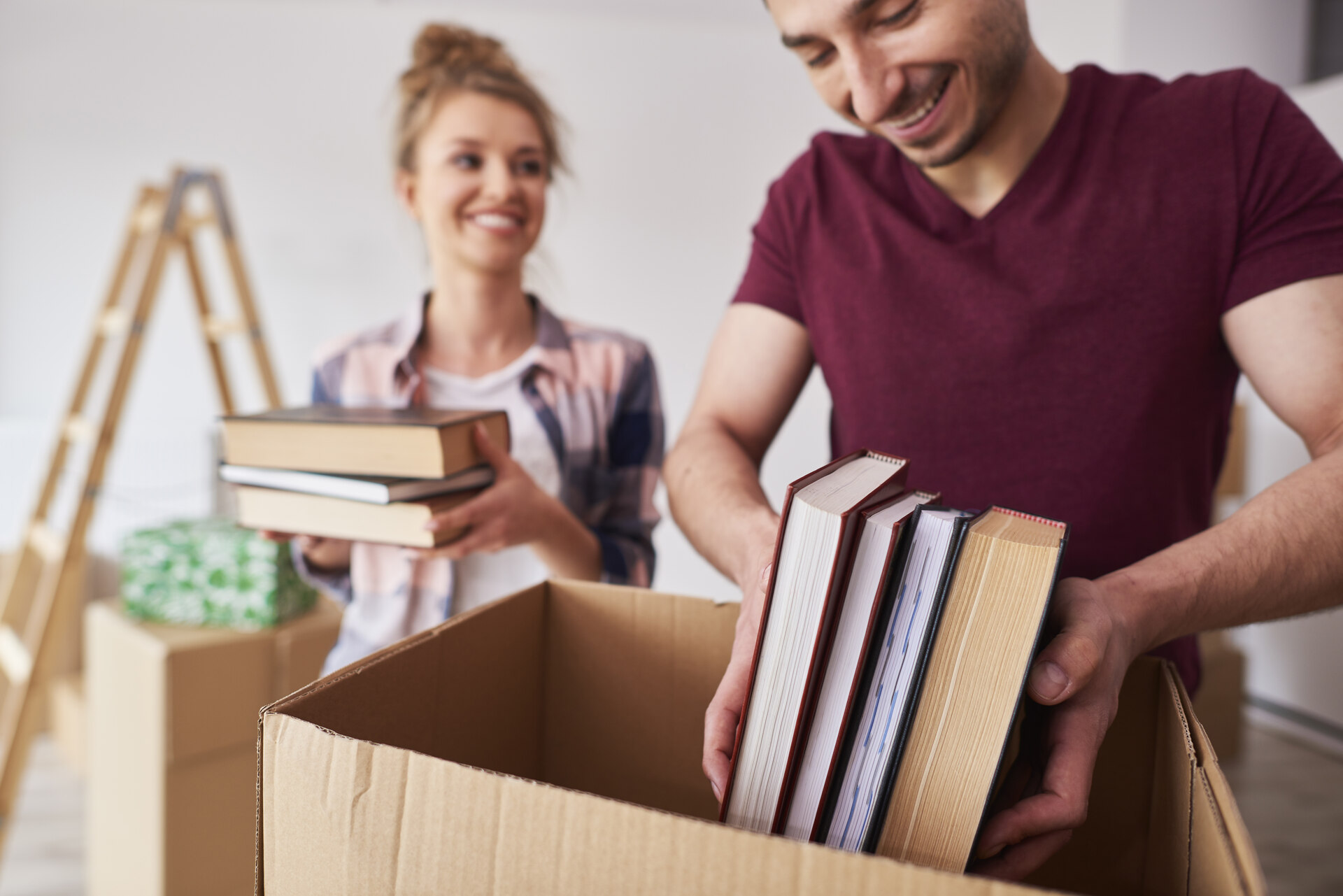 A couple packing books before moving internationally