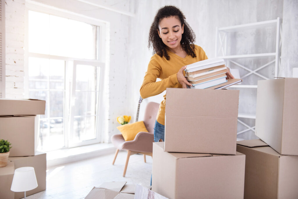 A girl packing books before moving overseas