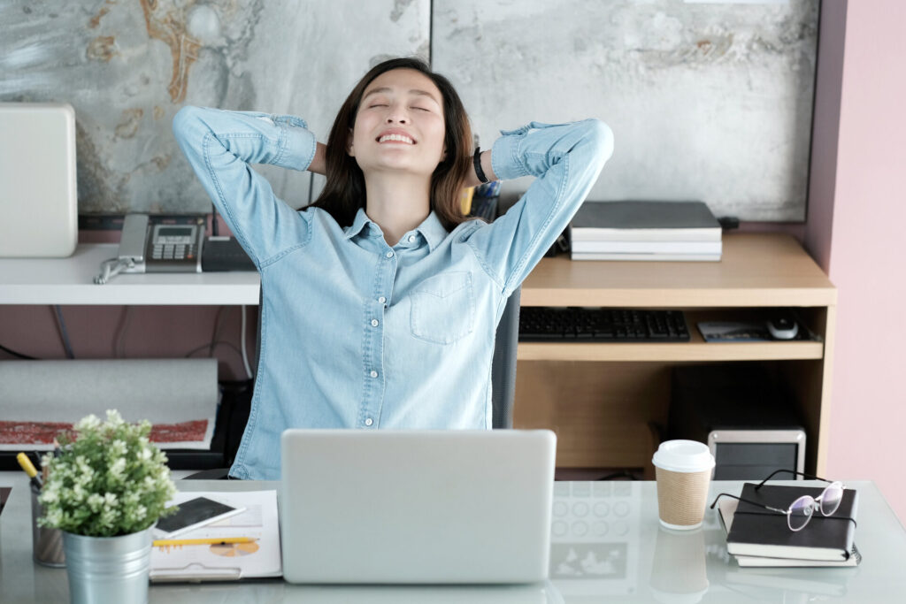 A woman smiling while sitting in an office chair