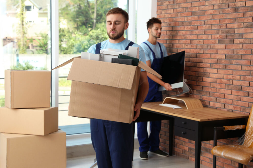 Professional movers packing office inventory