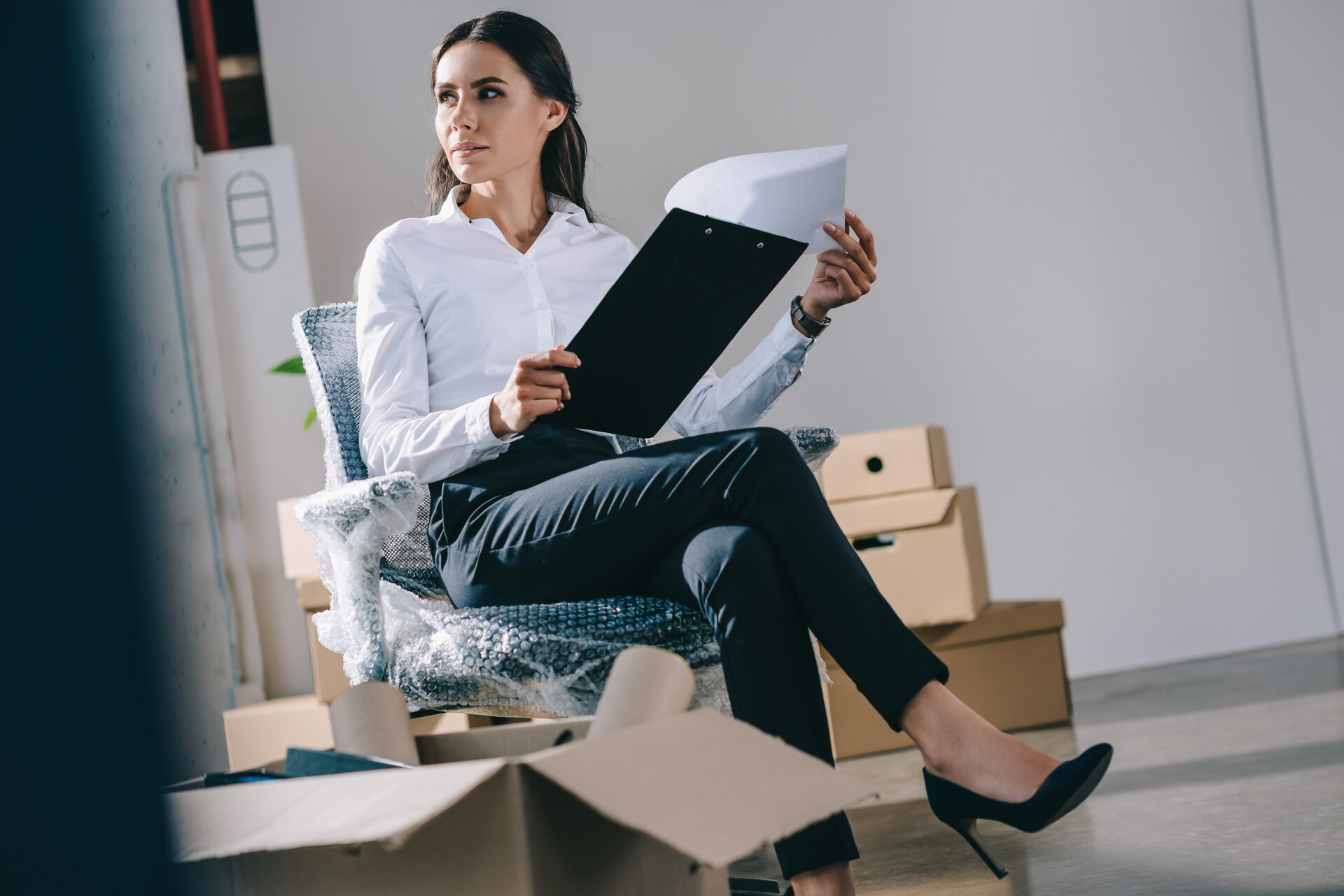 Woman sitting in a half-packed office