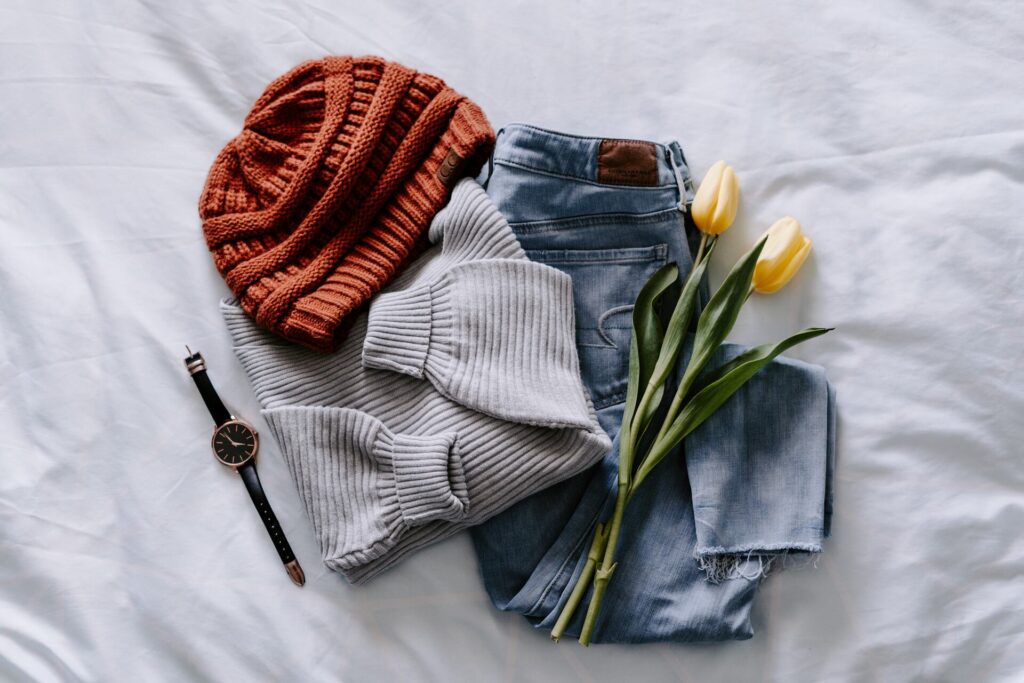 Clothes, flowers, and a watch on the bed